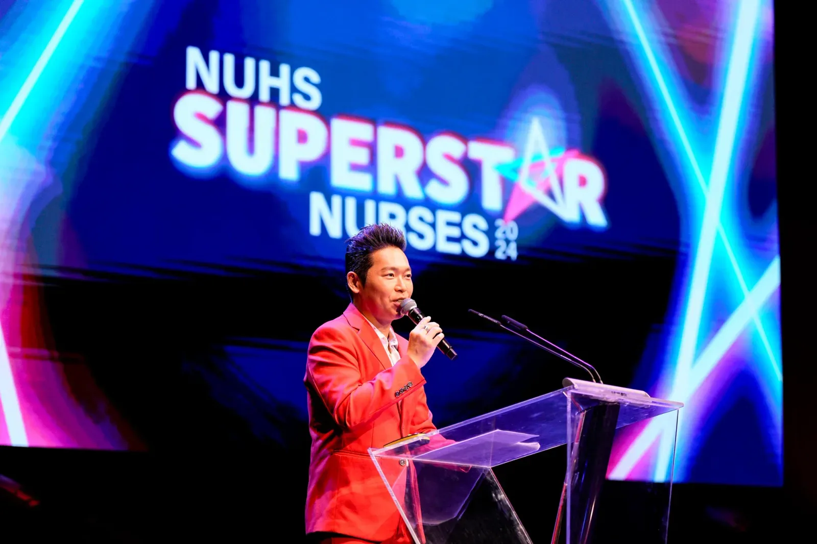 James Yang at the lectern hosting NUHS Superstar Nurses 2024
