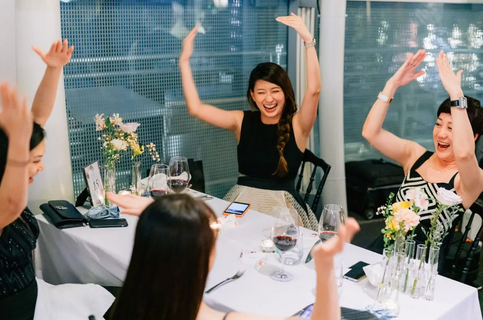 Wedding guests cheering with their arms up