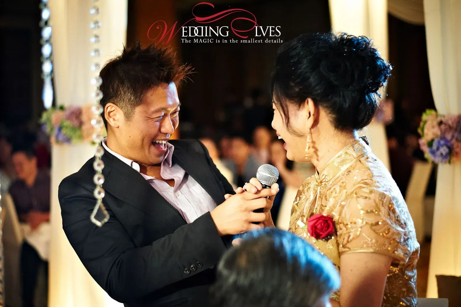 James Yang sharing a laugh with an older couple at a wedding