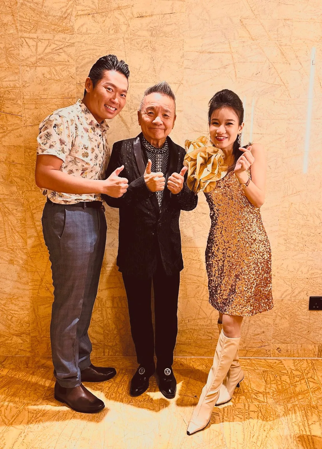 James Yang with two fellow performers, thumbs up
