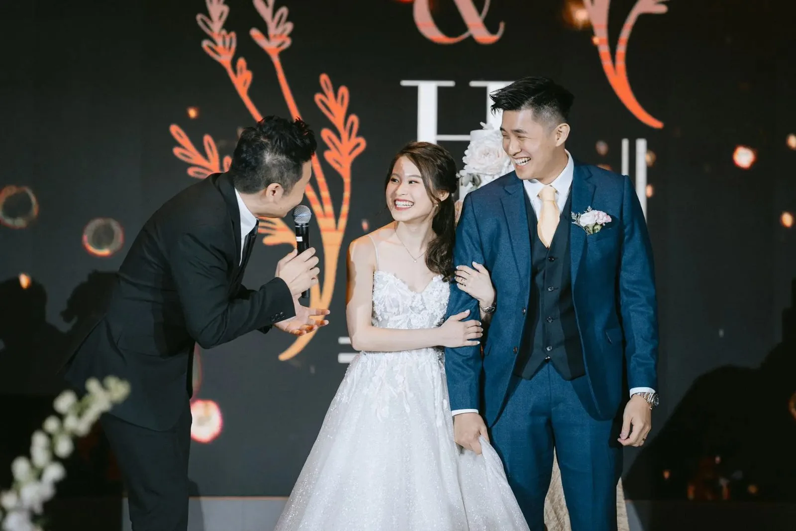 James Yang with the bride and groom at a rooftop wedding banquet in Singapore