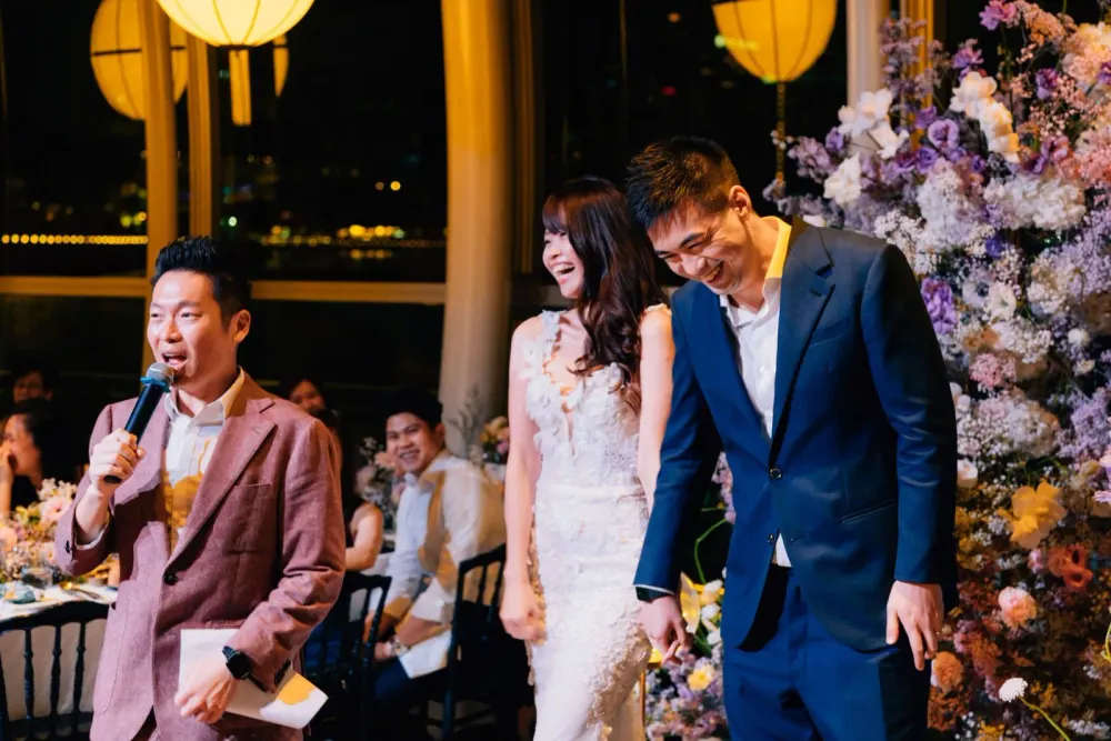 James Yang with a microphone during a wedding reception in Singapore